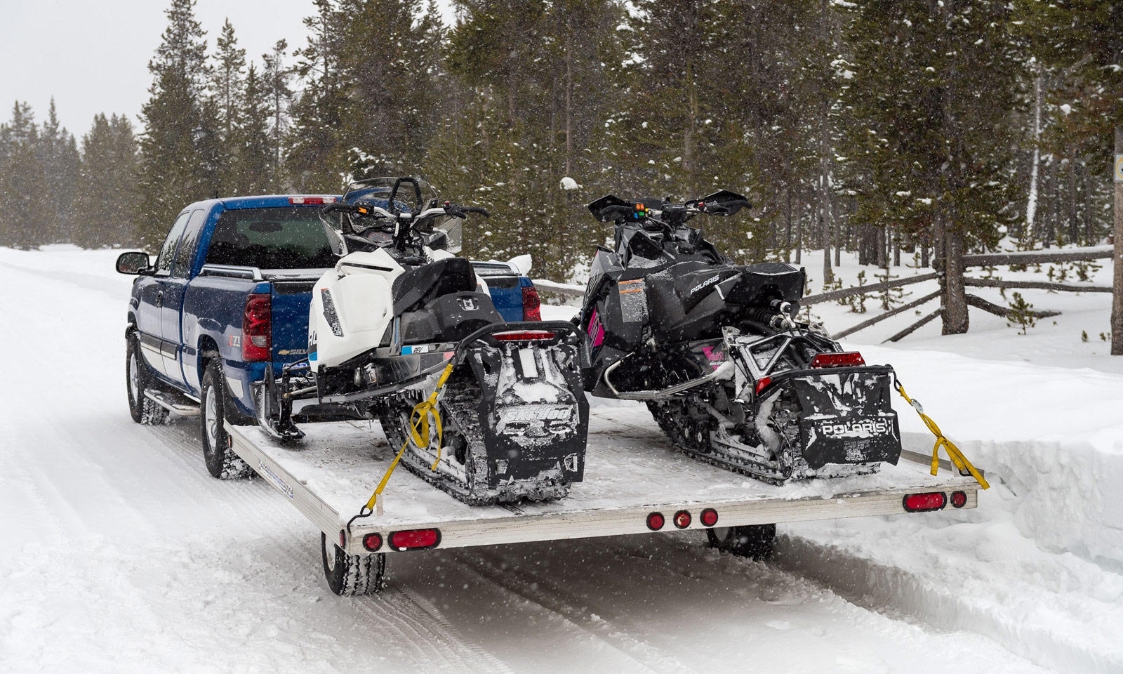 Pickup truck hauling two snowmobiles