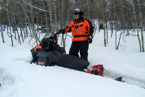 How to free your snowmobile from a snow bank