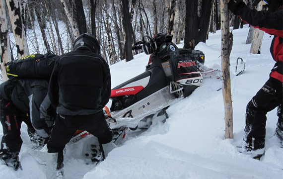 Snowmobile crashed into tree on slope