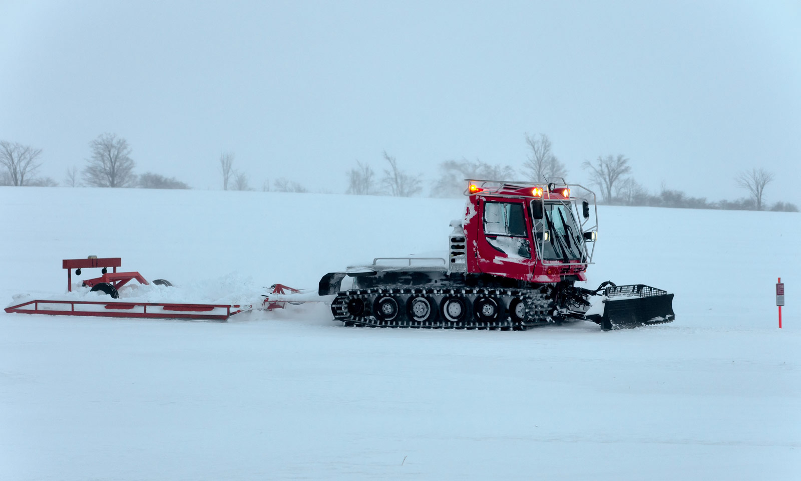 Snowmobile trail grooming machine