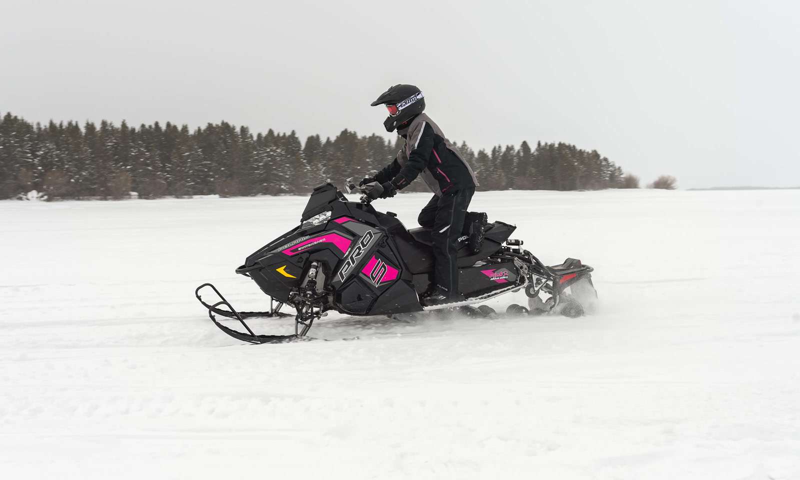 Snowmobiler riding on ice