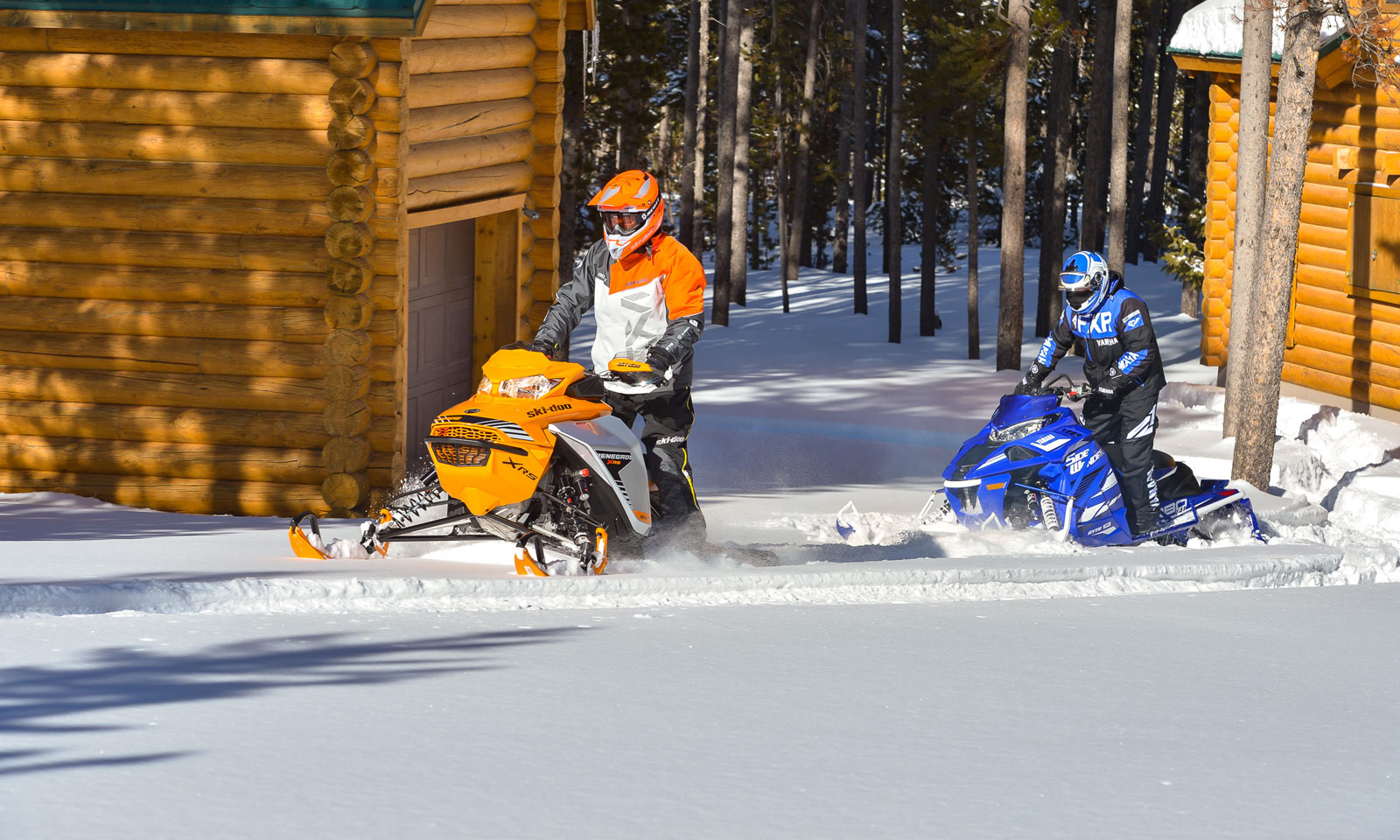 Sledders riding their snowmobiles